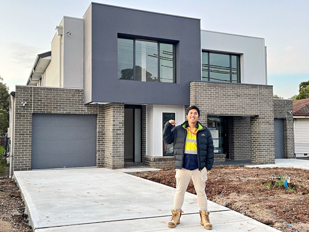 Zion Construction & Developments client in front of their completed duplex, Sydney